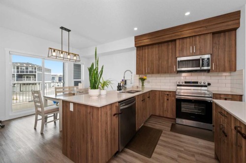 203-33 Merganser Drive, Chestermere, AB - Indoor Photo Showing Kitchen With Stainless Steel Kitchen