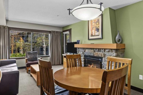 2109-250 2Nd Avenue, Dead Man'S Flats, AB - Indoor Photo Showing Dining Room With Fireplace