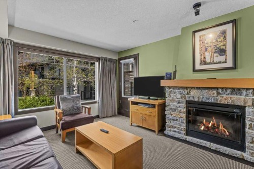 2109-250 2Nd Avenue, Dead Man'S Flats, AB - Indoor Photo Showing Living Room With Fireplace