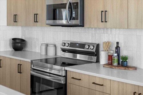 214 Greystone Boulevard, Cochrane, AB - Indoor Photo Showing Kitchen With Upgraded Kitchen