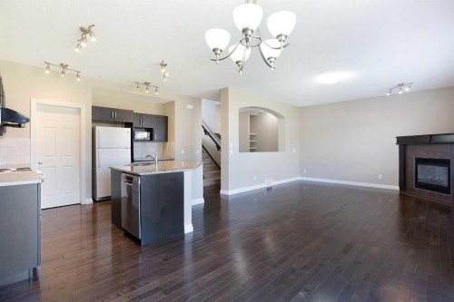 606 Montgomery Close Se, High River, AB - Indoor Photo Showing Kitchen With Fireplace
