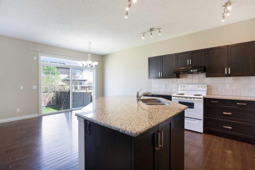 606 Montgomery Close Se, High River, AB - Indoor Photo Showing Kitchen With Double Sink