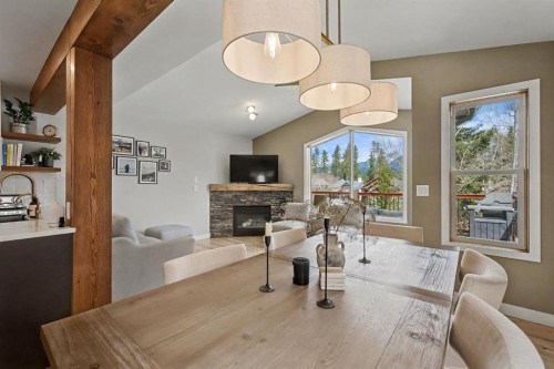 921 Lawrence Grassi Ridge, Canmore, AB - Indoor Photo Showing Dining Room With Fireplace