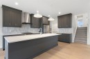125 Southborough Common, Cochrane, AB  - Indoor Photo Showing Kitchen With Upgraded Kitchen 