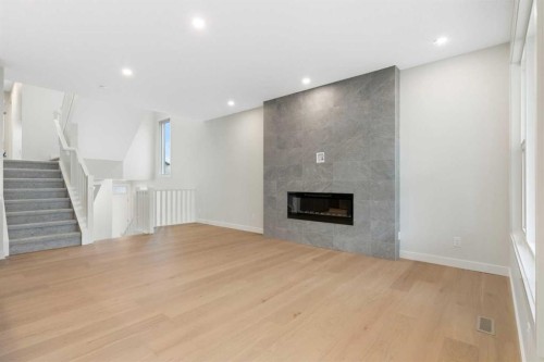 125 Southborough Common, Cochrane, AB - Indoor Photo Showing Other Room With Fireplace