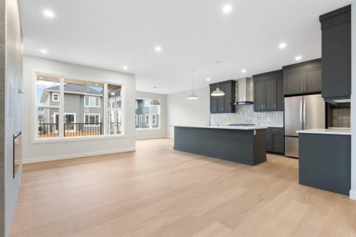 125 Southborough Common, Cochrane, AB - Indoor Photo Showing Kitchen With Stainless Steel Kitchen With Upgraded Kitchen