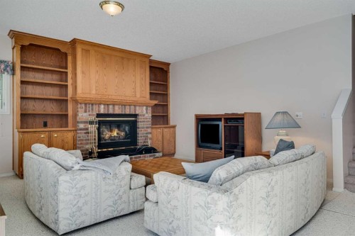 58 Evergreen Bay Sw, Calgary, AB - Indoor Photo Showing Living Room With Fireplace