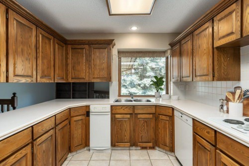 152 Coach Grove Place Sw, Calgary, AB - Indoor Photo Showing Kitchen With Double Sink