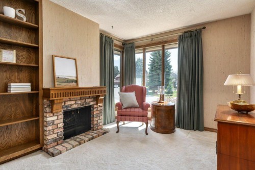 152 Coach Grove Place Sw, Calgary, AB - Indoor Photo Showing Living Room With Fireplace