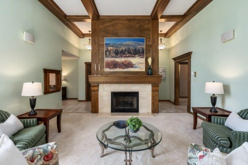 152 Coach Grove Place Sw, Calgary, AB - Indoor Photo Showing Living Room With Fireplace