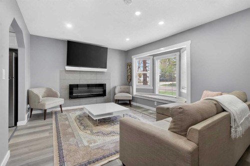 2418 27 Street Se, Calgary, AB - Indoor Photo Showing Living Room With Fireplace