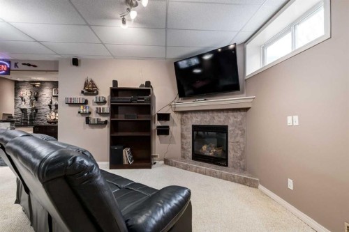 34 Morningside Landing Sw, Airdrie, AB - Indoor Photo Showing Other Room With Fireplace