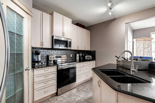 34 Morningside Landing Sw, Airdrie, AB - Indoor Photo Showing Kitchen With Double Sink