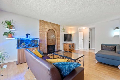 232 Ranchview Place Nw, Calgary, AB - Indoor Photo Showing Living Room With Fireplace