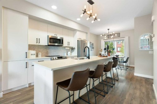1306 Jumping Pound Common, Cochrane, AB - Indoor Photo Showing Kitchen With Upgraded Kitchen