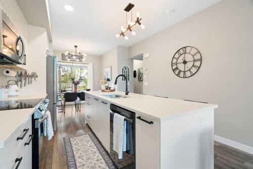 1306 Jumping Pound Common, Cochrane, AB - Indoor Photo Showing Kitchen With Upgraded Kitchen
