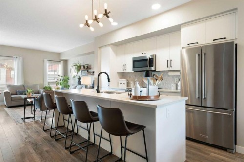 1306 Jumping Pound Common, Cochrane, AB - Indoor Photo Showing Kitchen With Upgraded Kitchen