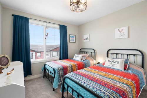 1306 Jumping Pound Common, Cochrane, AB - Indoor Photo Showing Bedroom