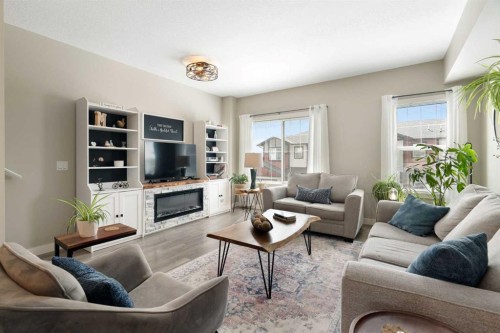 1306 Jumping Pound Common, Cochrane, AB - Indoor Photo Showing Living Room With Fireplace