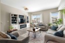 1306 Jumping Pound Common, Cochrane, AB  - Indoor Photo Showing Living Room With Fireplace 