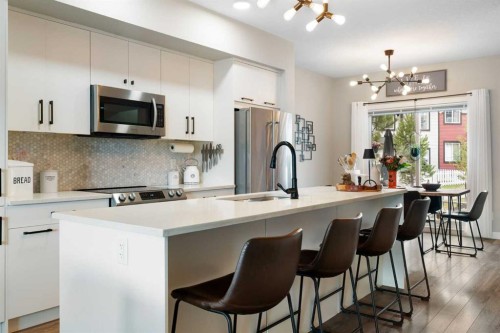 1306 Jumping Pound Common, Cochrane, AB - Indoor Photo Showing Kitchen With Upgraded Kitchen