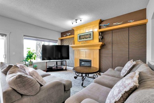 69-39 Strathlea Common Sw, Calgary, AB - Indoor Photo Showing Living Room With Fireplace