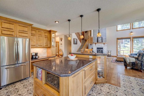 4 Highlands Place, Bragg Creek, AB - Indoor Photo Showing Kitchen With Fireplace