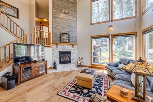 4 Highlands Place, Bragg Creek, AB - Indoor Photo Showing Living Room With Fireplace