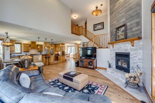 4 Highlands Place, Bragg Creek, AB - Indoor Photo Showing Living Room With Fireplace