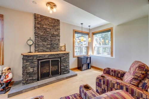 4 Highlands Place, Bragg Creek, AB - Indoor Photo Showing Living Room With Fireplace