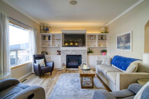 228 Oakmere Place, Chestermere, AB - Indoor Photo Showing Living Room With Fireplace
