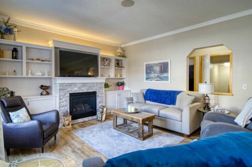 228 Oakmere Place, Chestermere, AB - Indoor Photo Showing Living Room With Fireplace
