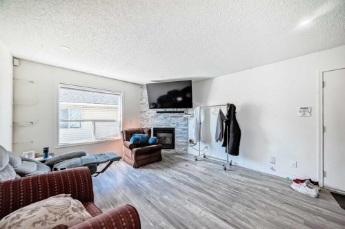 125 Coral Springs Bay Ne, Calgary, AB - Indoor Photo Showing Living Room With Fireplace