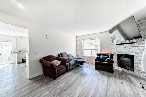 125 Coral Springs Bay Ne, Calgary, AB - Indoor Photo Showing Living Room With Fireplace