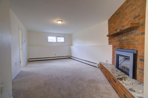 664 49 Avenue West, Claresholm, AB - Indoor Photo Showing Other Room With Fireplace