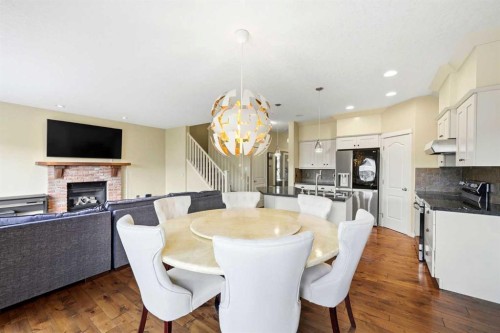 7942 Cougar Ridge Avenue Sw, Calgary, AB - Indoor Photo Showing Dining Room With Fireplace