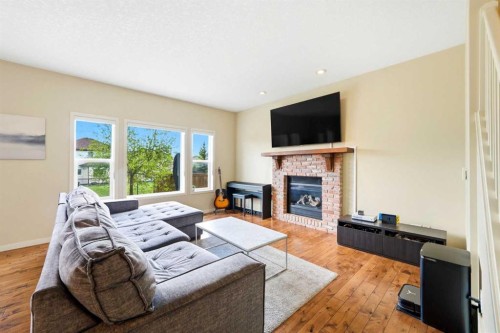 7942 Cougar Ridge Avenue Sw, Calgary, AB - Indoor Photo Showing Living Room With Fireplace