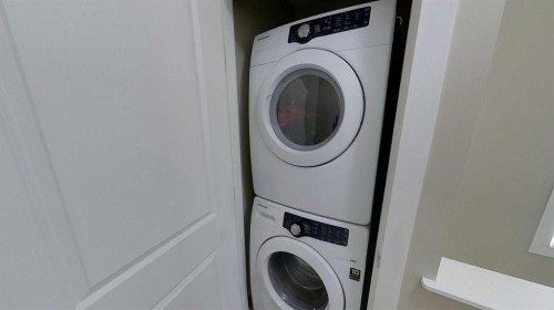 54 New Brighton Point Se, Calgary, AB - Indoor Photo Showing Laundry Room