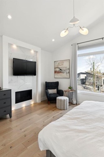 1424 27 Street Sw, Calgary, AB - Indoor Photo Showing Bedroom With Fireplace