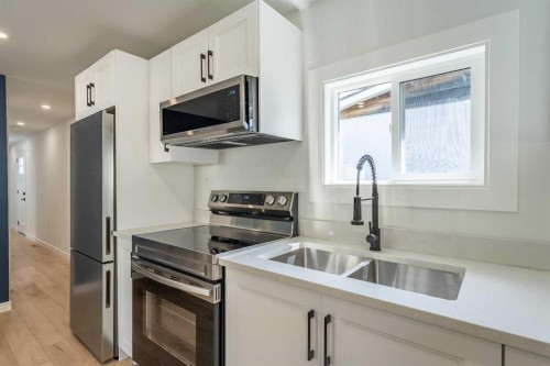 36 Big Hill Way Se, Airdrie, AB - Indoor Photo Showing Kitchen With Stainless Steel Kitchen With Double Sink