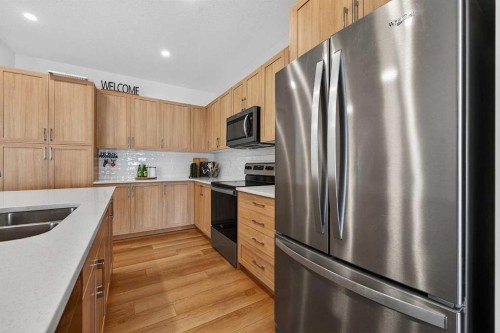 309 Baneberry Way Sw, Airdrie, AB - Indoor Photo Showing Kitchen With Stainless Steel Kitchen With Double Sink