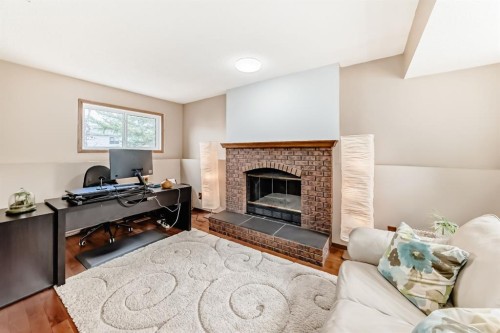 118 Sandpiper Way Nw, Calgary, AB - Indoor Photo Showing Living Room With Fireplace