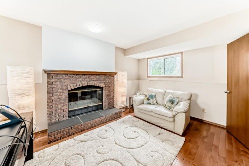 118 Sandpiper Way Nw, Calgary, AB - Indoor Photo Showing Living Room With Fireplace