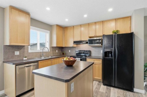 213 Silverado Drive Sw, Calgary, AB - Indoor Photo Showing Kitchen With Double Sink