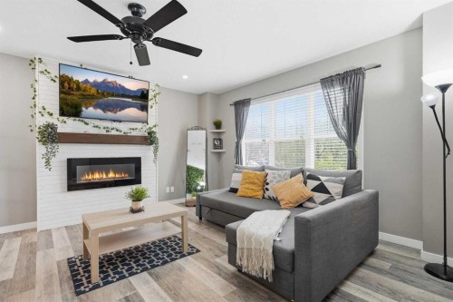 213 Silverado Drive Sw, Calgary, AB - Indoor Photo Showing Living Room With Fireplace
