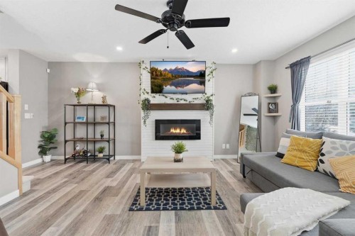 213 Silverado Drive Sw, Calgary, AB - Indoor Photo Showing Living Room With Fireplace