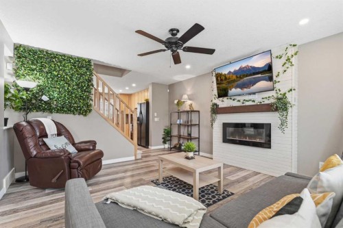 213 Silverado Drive Sw, Calgary, AB - Indoor Photo Showing Living Room With Fireplace