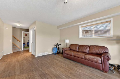 44 Bridlepost Green Sw, Calgary, AB - Indoor Photo Showing Living Room