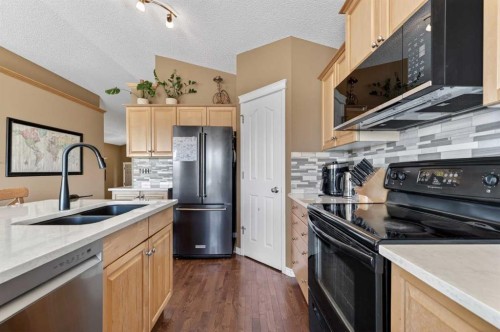 44 Bridlepost Green Sw, Calgary, AB - Indoor Photo Showing Kitchen With Double Sink With Upgraded Kitchen