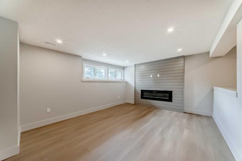 1115 Lake Wapta Road Se, Calgary, AB - Indoor Photo Showing Other Room With Fireplace